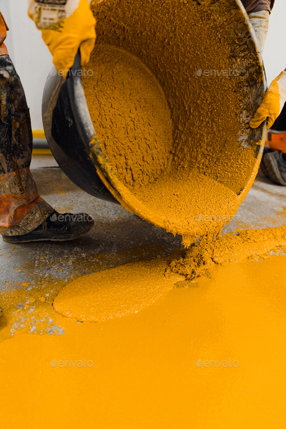 epoxy flooring applicator performs painting works with polyurethane